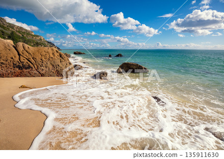 Galapinhos beach on a sunny day. Rocky seascape. Setubal region, Atlantic Ocean, Portugal Galapinhos beach on a sunny day. Rocky seascape. Setubal region, Atlantic Ocean, Portugal 135911630