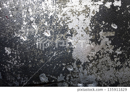 Worn Aluminum Sheet With Scratched Paint, A gritty ad photo of worn aluminum sheet with scratched paint, metallic scars gleaming in harsh light, for industrial durability or raw texture documentary. 135911829