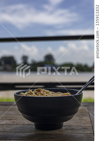 Instant Noodles, Tom Yum Kung Flavor, A steaming ad photo of instant noodles Tom Yum Kung flavor, shrimp and lime in spicy broth, perfect for quick Thai meal campaign or bold spice documentary. 135911832