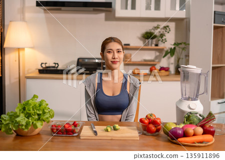 Fit woman enjoys healthy fruit breakfast after yoga training, fitness, looking to camera. Fit woman enjoys healthy fruit breakfast after yoga training, fitness, looking to camera. 135911896