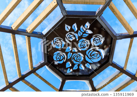 Winter scenery of Gifu World Rose Garden with snow still remaining on the rose-decorated roof and blue sky Winter scenery of Gifu World Rose Garden with snow still remaining on the rose-decorated roof and blue sky 135911969