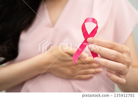 Asian woman with pink ribbon, World Breast Cancer Day at October. 135912781