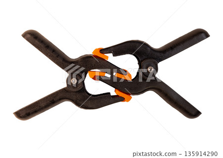 Two black spring clamps interlocked with orange pivoting jaw pads 135914290