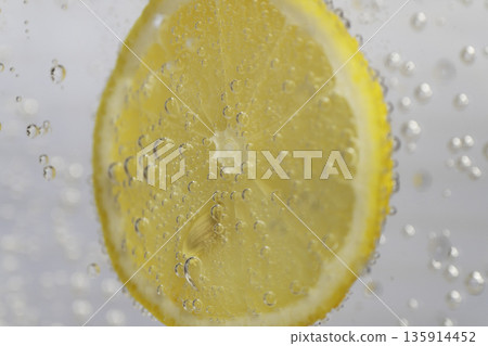 Close-up of a lemon with bubbles floating in water Close-up of a lemon with bubbles floating in water 135914452