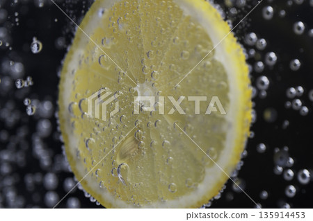 Close-up of a lemon with bubbles floating in water Close-up of a lemon with bubbles floating in water 135914453
