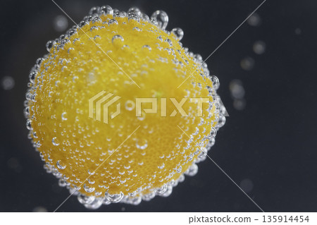 Close-up of kumquats with air bubbles floating in water Close-up of kumquats with air bubbles floating in water 135914454