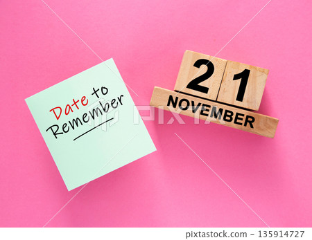 Date November 21 to remember concept with sticky note and wooden calendar Date November 21 to remember concept with sticky note and wooden calendar 135914727