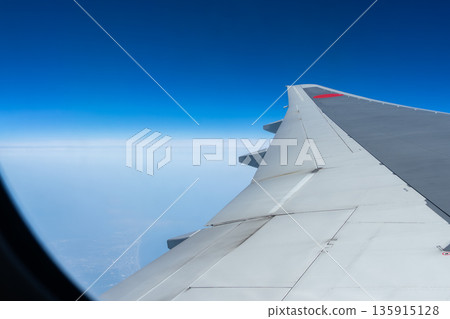 A blue sky seen from an airplane 135915128
