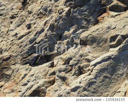 Rock and sand art. Enjoy the seascape. Copy space. An artistic background woven by nature. 135916155