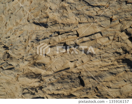 Rock and sand art. Enjoy the seascape. Copy space. An artistic background woven by nature. Rock and sand art. Enjoy the seascape. Copy space. An artistic background woven by nature. 135916157