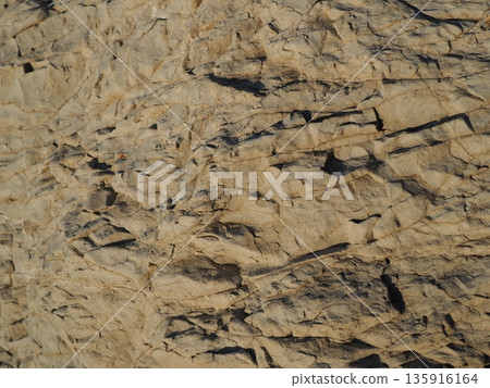 Rock and sand art. Enjoy the seascape. Copy space. An artistic background woven by nature. Rock and sand art. Enjoy the seascape. Copy space. An artistic background woven by nature. 135916164
