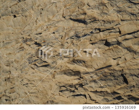 Rock and sand art. Enjoy the seascape. Copy space. An artistic background woven by nature. Rock and sand art. Enjoy the seascape. Copy space. An artistic background woven by nature. 135916169