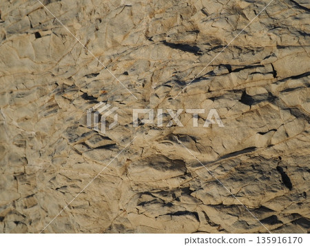 Rock and sand art. Enjoy the seascape. Copy space. An artistic background woven by nature. Rock and sand art. Enjoy the seascape. Copy space. An artistic background woven by nature. 135916170