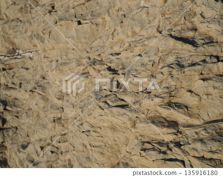 Rock and sand art. Enjoy the seascape. Copy space. An artistic background woven by nature. Rock and sand art. Enjoy the seascape. Copy space. An artistic background woven by nature. 135916180