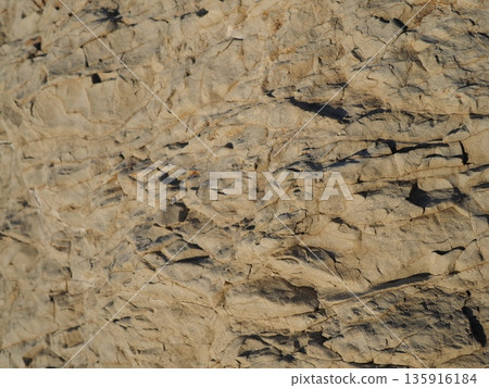 Rock and sand art. Enjoy the seascape. Copy space. An artistic background woven by nature. Rock and sand art. Enjoy the seascape. Copy space. An artistic background woven by nature. 135916184