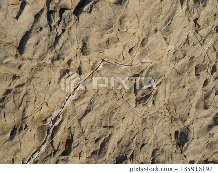 Rock and sand art. Enjoy the seascape. Copy space. An artistic background woven by nature. 135916192