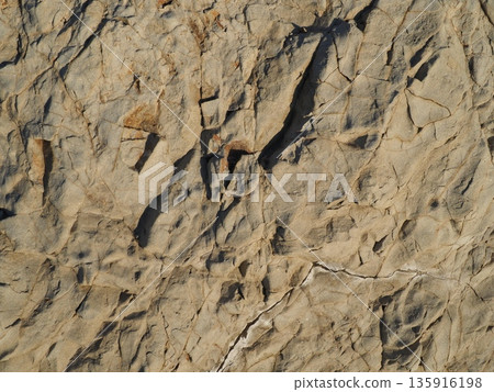 Rock and sand art. Enjoy the seascape. Copy space. An artistic background woven by nature. Rock and sand art. Enjoy the seascape. Copy space. An artistic background woven by nature. 135916198