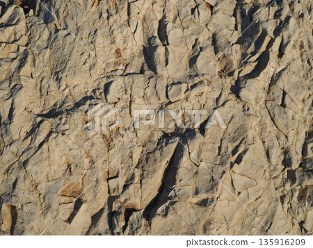 Rock and sand art. Enjoy the seascape. Copy space. An artistic background woven by nature. Rock and sand art. Enjoy the seascape. Copy space. An artistic background woven by nature. 135916209
