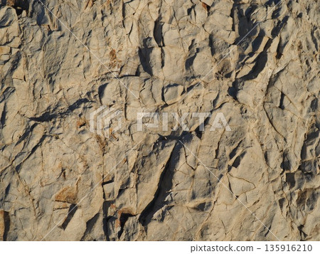 Rock and sand art. Enjoy the seascape. Copy space. An artistic background woven by nature. 135916210