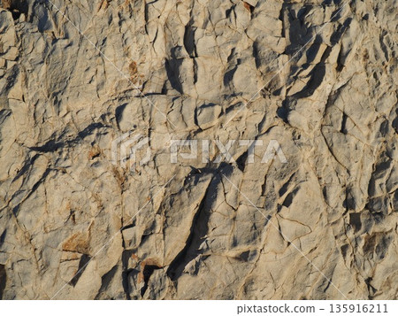 Rock and sand art. Enjoy the seascape. Copy space. An artistic background woven by nature. Rock and sand art. Enjoy the seascape. Copy space. An artistic background woven by nature. 135916211