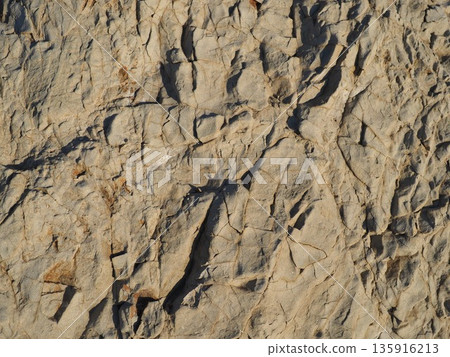 Rock and sand art. Enjoy the seascape. Copy space. An artistic background woven by nature. Rock and sand art. Enjoy the seascape. Copy space. An artistic background woven by nature. 135916213