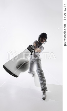 Female cricket player striking ball with bat during forward drive in studio Female cricket player striking ball with bat during forward drive in studio 135916713