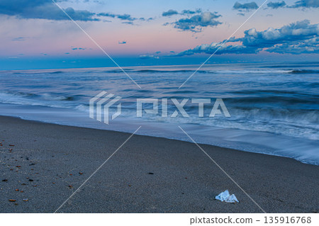 Jewelry ice and the twilight sky on a winter beach Jewelry ice and the twilight sky on a winter beach 135916768