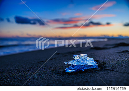Jewelry ice sparkling in the ocean at dusk 135916769