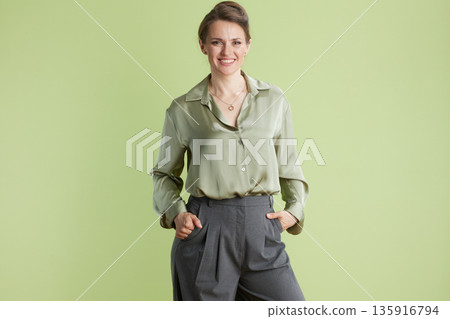 Smiling professional woman in green Smiling professional woman in green 135916794