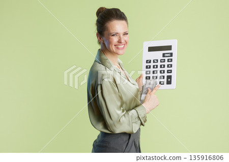 Woman with Calculator and Currency: Financial Focus. 135916806