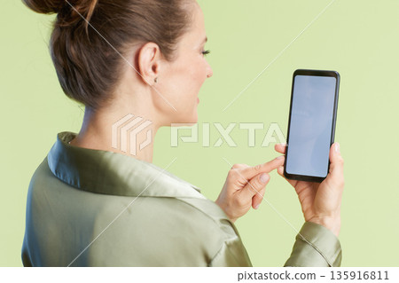 Woman with Bun Touches Smartphone Woman with Bun Touches Smartphone 135916811