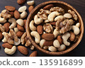 Mixed nuts in a wooden bowl Mixed nuts in a wooden bowl 135916899