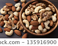 Mixed nuts in a wooden bowl Mixed nuts in a wooden bowl 135916900