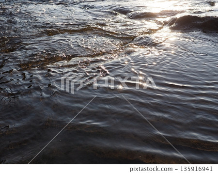 Art of light reflected on the water surface. Copy space. Water art background. Art of a moment. Cherish that moment. 135916941