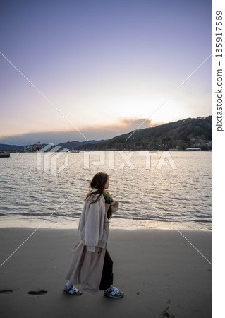 Evening sea and sky and young woman 135917569