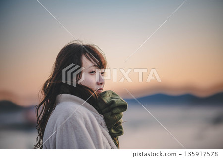 Evening sea and sky and young woman Evening sea and sky and young woman 135917578