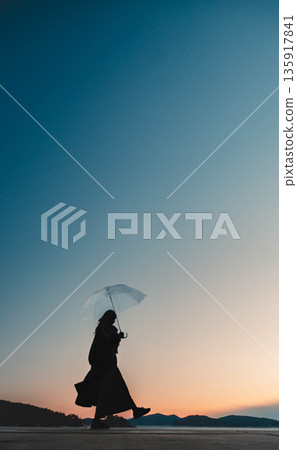 Fantastic evening sky and woman Fantastic evening sky and woman 135917841
