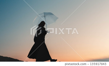 Fantastic evening sky and woman Fantastic evening sky and woman 135917843