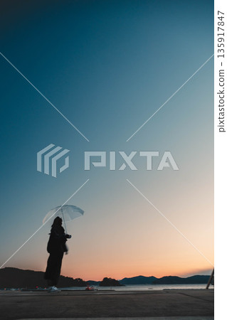 Fantastic evening sky and woman Fantastic evening sky and woman 135917847