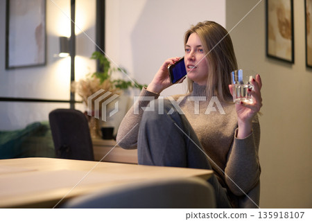 Calm Phone Call with a Glass of Water at the Table 135918107