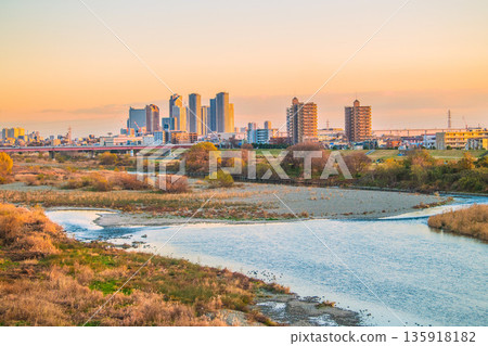 New Year's Day in Kawasaki, Japan. A winter view of the Tama River and the tower apartment complexes in front of Musashi-Kosugi Station. Towards a golden age. 135918182