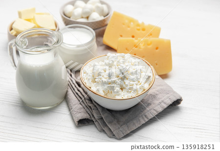 Dairy products assortment displaying milk, various cheeses, and butter 135918251