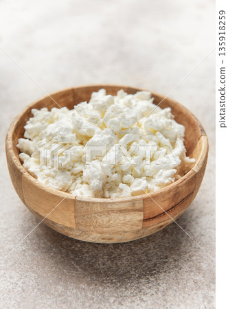 Cottage cheese in wooden bowl for healthy breakfast Cottage cheese in wooden bowl for healthy breakfast 135918259
