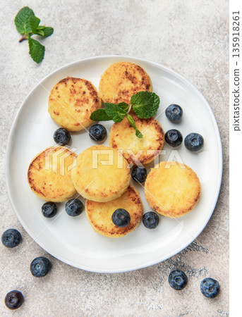Homemade syrniki cottage cheese pancakes with blueberries and mint 135918261