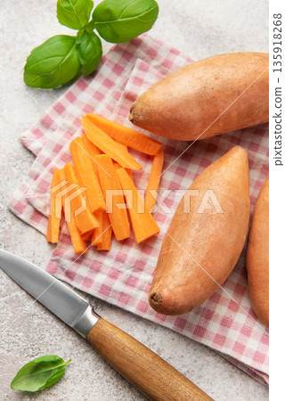 Preparing sweet potato fries with knife and basil on napkin 135918268