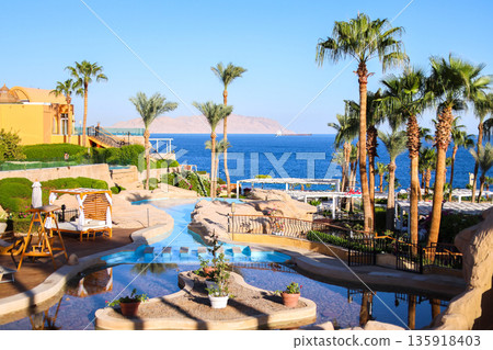 A resort landscape of an Egyptian hotel overlooking Tiran Island A resort landscape of an Egyptian hotel overlooking Tiran Island 135918403