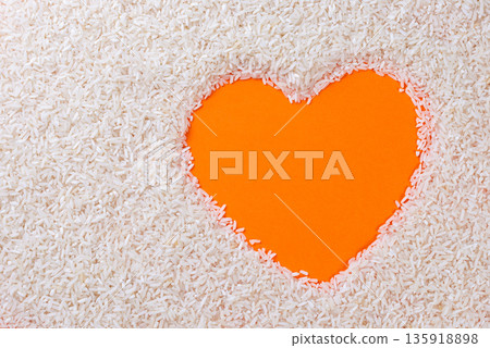 Orange heart shape on sand background. Minimal love and emotion concept with warm summer feeling. Orange heart shape on sand background. Minimal love and emotion concept with warm summer feeling. 135918898