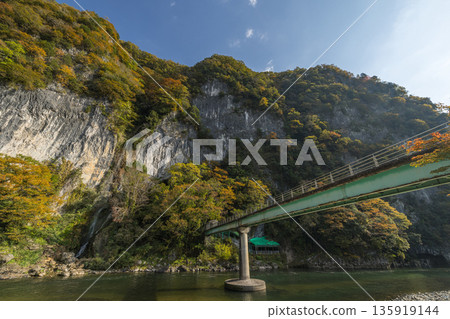 Takahashi River flowing along Ikura Gorge in Niimi City, Okayama Prefecture, Japan, with autumn leaves and Ikura Falls 135919144