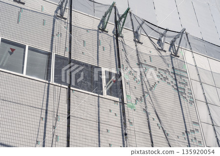 Building repair work: Repairing exterior wall tiles 135920054
