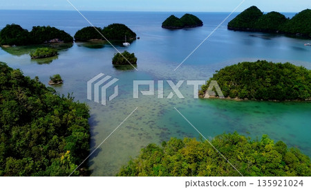 Aerial drone FPV showing the coastal area, mall islands and clear blue sea in Tinagong Dagat, a famous ecotourism attraction in Sipalay, Negros Occidental, Philippines Aerial drone FPV showing the coastal area, mall islands and clear blue sea in Tinagong Dagat, a famous ecotourism attraction in Sipalay, Negros Occidental, Philippines 135921024